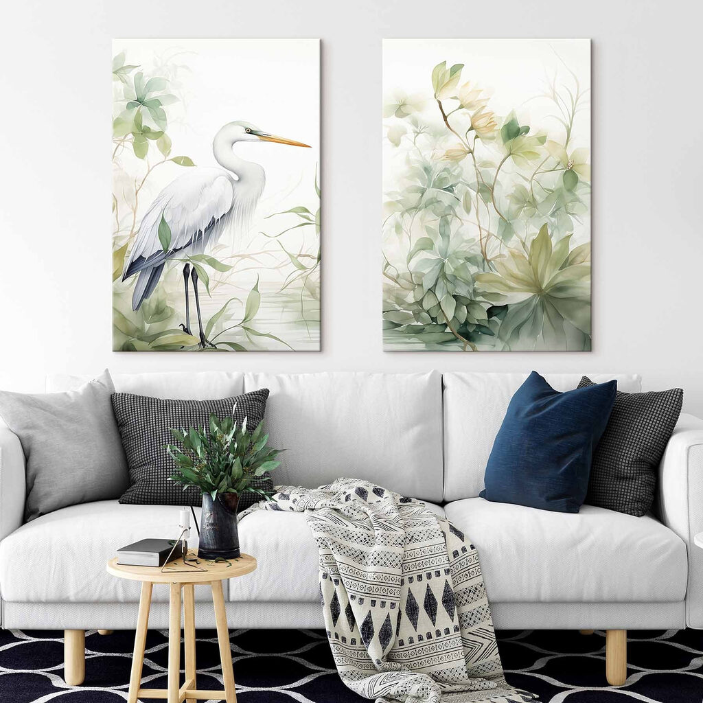White bird with a long beak and a long beak standing in front of a plant